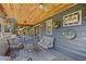 Relaxing screened patio with wood ceiling, decorative lighting and comfortable seating area at 3106 Whispering S Dr, Largo, FL 33771