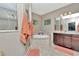 Bright bathroom featuring a soaking tub, walk-in shower, and double vanity sinks for a spa-like experience at 3408 W Bay Ave, Tampa, FL 33611