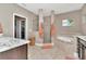 Lavish bathroom with a large soaking tub, glass shower, and elegant vanity area at 3408 W Bay Ave, Tampa, FL 33611