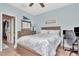 Bedroom with bed, desk, ceiling fan and carpeted floor with neutral walls and wooden dresser at 3408 W Bay Ave, Tampa, FL 33611