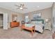 Spacious bedroom featuring a king bed, ceiling fan, and carpet floors creating a cozy retreat at 3408 W Bay Ave, Tampa, FL 33611