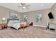 Inviting bedroom with a plush king bed, two windows, and a dedicated desk area at 3408 W Bay Ave, Tampa, FL 33611