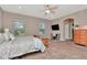 Relaxing bedroom featuring a bed, ceiling fan, dresser and desk area for a peaceful ambiance at 3408 W Bay Ave, Tampa, FL 33611