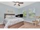 Bedroom with a queen bed, ceiling fan, carpeted floor, and windows providing natural light at 3408 W Bay Ave, Tampa, FL 33611