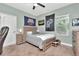 Bedroom with ceiling fan, carpeted floor, neutral paint, and a single bed and wooden dresser at 3408 W Bay Ave, Tampa, FL 33611