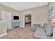 Cozy bonus room featuring neutral carpet, contemporary furniture, and easy access to other living spaces at 3408 W Bay Ave, Tampa, FL 33611