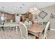 Open kitchen and dining room with decorative lighting and hardwood floors at 3408 W Bay Ave, Tampa, FL 33611