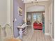 Welcoming entryway with light wood floors, light purple walls, and elegant decor, setting a stylish tone for the home at 3408 W Bay Ave, Tampa, FL 33611