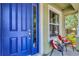 Inviting front porch showcasing a blue front door and seating area, perfect for relaxing and enjoying the outdoors at 3408 W Bay Ave, Tampa, FL 33611