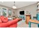 Cozy living room with hardwood floors, large TV, and comfortable seating, ideal for relaxing and watching movies at 3408 W Bay Ave, Tampa, FL 33611