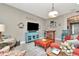 Bright living room featuring hardwood floors, colorful accents, and a comfortable seating arrangement at 3408 W Bay Ave, Tampa, FL 33611