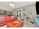 Inviting living room with an open layout to the kitchen, complete with hardwood floors and access to the backyard at 3408 W Bay Ave, Tampa, FL 33611