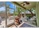 Covered porch features dining and seating area, and access to the backyard, screened for comfort at 3408 W Bay Ave, Tampa, FL 33611