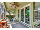 Covered, screened porch features outdoor seating, ceiling fan, and access to the backyard and natural light at 3408 W Bay Ave, Tampa, FL 33611
