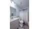 Bathroom featuring a vanity with mirror, a toilet, and a shower with a patterned curtain at 428 Flamingo Dr, Apollo Beach, FL 33572