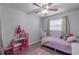Bedroom with pink decor, a dresser, and a ceiling fan at 428 Flamingo Dr, Apollo Beach, FL 33572