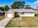 Charming single-story home featuring a blend of stucco and stone facade plus an attached single car garage at 428 Flamingo Dr, Apollo Beach, FL 33572
