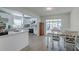 Modern kitchen and dining area featuring sleek cabinetry and backyard access at 428 Flamingo Dr, Apollo Beach, FL 33572