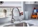 Close-up of a kitchen sink featuring modern fixtures and natural light from the window at 428 Flamingo Dr, Apollo Beach, FL 33572