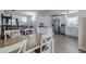 Open-concept living room with a kitchen featuring white cabinets and a comfortable gray sofa at 428 Flamingo Dr, Apollo Beach, FL 33572