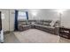 Spacious living room with a large sectional sofa, neutral color palette, and ample natural light at 428 Flamingo Dr, Apollo Beach, FL 33572