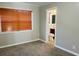 Cozy bedroom featuring carpet and a window with wooden blinds at 4310 7Th S St, St Petersburg, FL 33705
