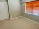 Bedroom with tile floor and natural light from window with wooden blinds at 4310 7Th S St, St Petersburg, FL 33705