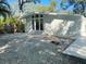 Home exterior showing a gravel backyard and large windows bringing in natural light at 4310 7Th S St, St Petersburg, FL 33705