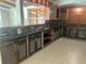 Kitchen featuring stainless steel appliances, dark countertops, and glass cabinets at 4310 7Th S St, St Petersburg, FL 33705