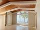 Sunlit living room showcasing high ceilings, exposed beams, and large windows at 4310 7Th S St, St Petersburg, FL 33705