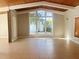 Bright living room boasting beamed wood ceiling, large window, and neutral tile floors at 4310 7Th S St, St Petersburg, FL 33705