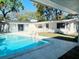 Inviting swimming pool with a clean tile deck and glimpses of the home's exterior at 4310 7Th S St, St Petersburg, FL 33705