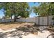 Large backyard featuring a storage shed, shade trees, and white fencing at 4550 53Rd N Ave, St Petersburg, FL 33714