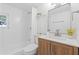 Bright bathroom with a modern vanity, tub with shower, and white subway tile at 4550 53Rd N Ave, St Petersburg, FL 33714