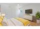 Bedroom features wood floors, neutral paint, a ceiling fan and television at 4550 53Rd N Ave, St Petersburg, FL 33714