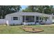 Charming white home features a lovely screened-in porch and fresh landscaping at 4550 53Rd N Ave, St Petersburg, FL 33714