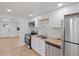 Modern kitchen with stainless appliances, white cabinets, butcher block counters and wood flooring at 4550 53Rd N Ave, St Petersburg, FL 33714