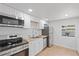 Updated kitchen features stainless steel appliances, white cabinets, and butcher block countertops at 4550 53Rd N Ave, St Petersburg, FL 33714