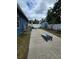 Backyard features a concrete patio with cornhole boards and a shed, perfect for outdoor games and storage at 4601 N 38Th St, Tampa, FL 33610