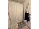 Clean bathroom features a simple shower with neutral-colored curtain and a decorative bath mat, creating a soothing space at 4601 N 38Th St, Tampa, FL 33610