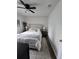 This calming bedroom has wood-look flooring, a patterned accent wall, and a queen sized bed at 4601 N 38Th St, Tampa, FL 33610