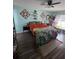 This bedroom features light-blue painted walls, hardwood flooring, and natural light from the bright window at 4601 N 38Th St, Tampa, FL 33610