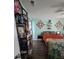 This charming bedroom is furnished with colorful decor, a queen size bed, and an eclectic bookshelf at 4601 N 38Th St, Tampa, FL 33610