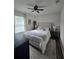 Inviting bedroom featuring a ceiling fan, wood floors, and bright natural lighting at 4601 N 38Th St, Tampa, FL 33610