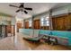 Unfinished basement with tiled floor, teal trim, utility sink, and exposed wall studs presents a blank canvas for customization at 512 79Th Ave, St Pete Beach, FL 33706