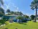 Charming home with lush landscaping, mature palms, and a beautiful turquoise exterior at 512 79Th Ave, St Pete Beach, FL 33706