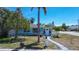 Inviting turquoise home with lush landscaping, mature palms, and a paved walkway leading to the entrance at 512 79Th Ave, St Pete Beach, FL 33706