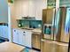Modern kitchen features stainless steel appliances, white cabinets, and a stylish backsplash at 512 79Th Ave, St Pete Beach, FL 33706