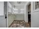Sunroom with white walls, windowed walls, white blinds, and door to the left at 512 79Th Ave, St Pete Beach, FL 33706