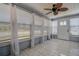 Sunroom featuring white tile flooring and curtains on the many windows at 512 79Th Ave, St Pete Beach, FL 33706